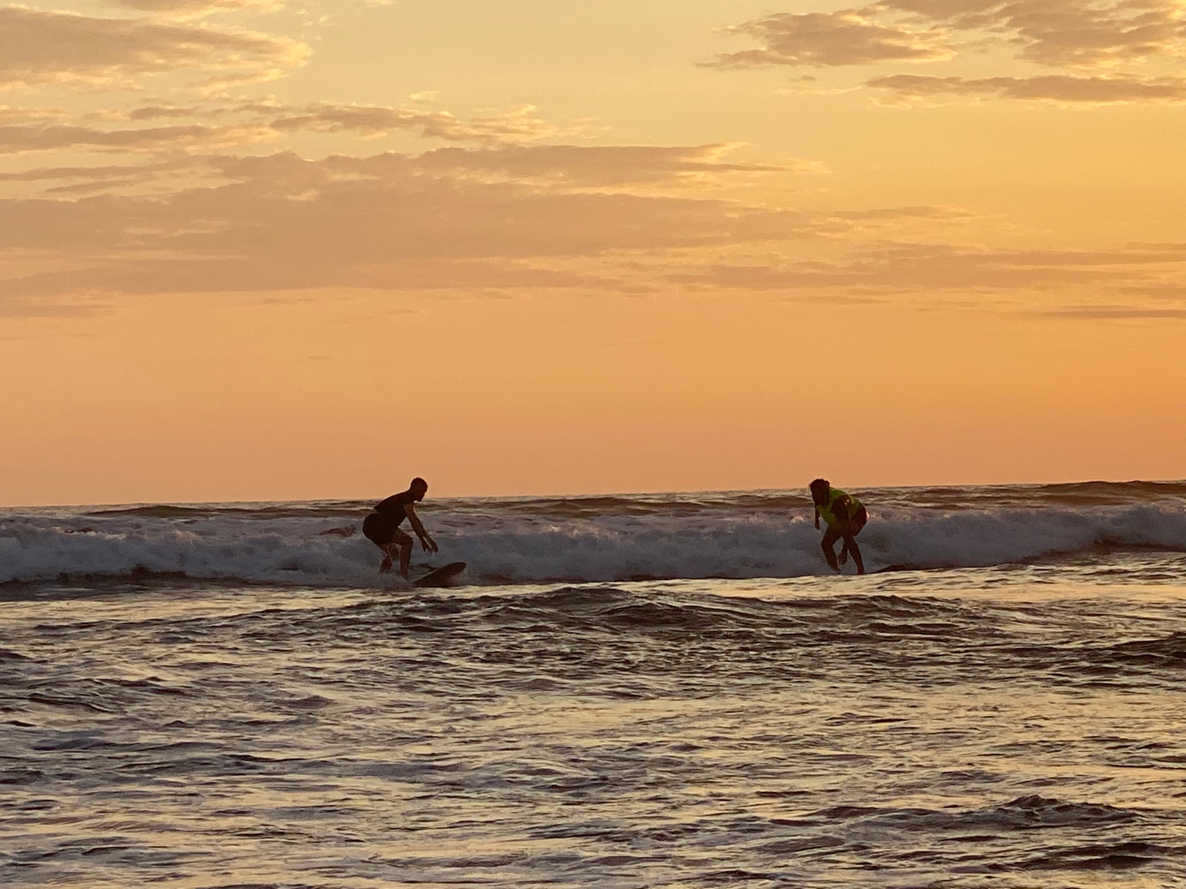 Josh and a partner catching a wave — the inspiration behind SameWave